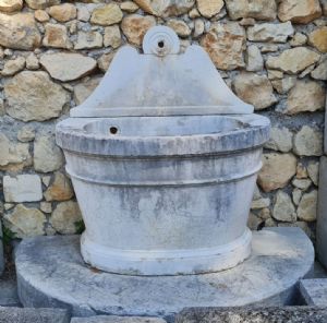 Botticino marble fountain with riser and base.